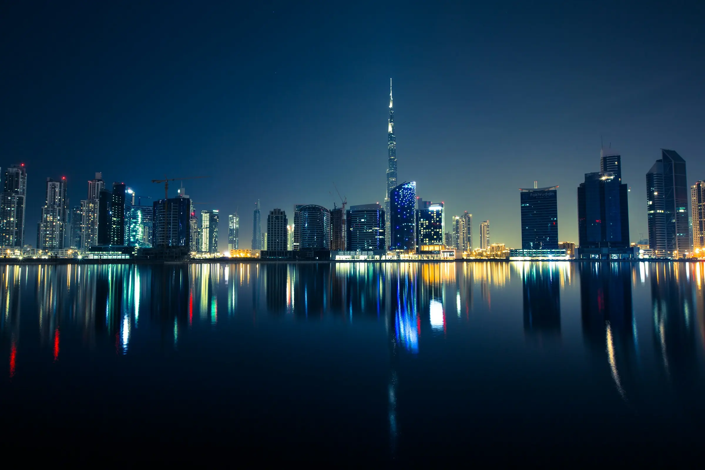 Downtown Dubai and the Burj Khalifa at night, reflected in the water
