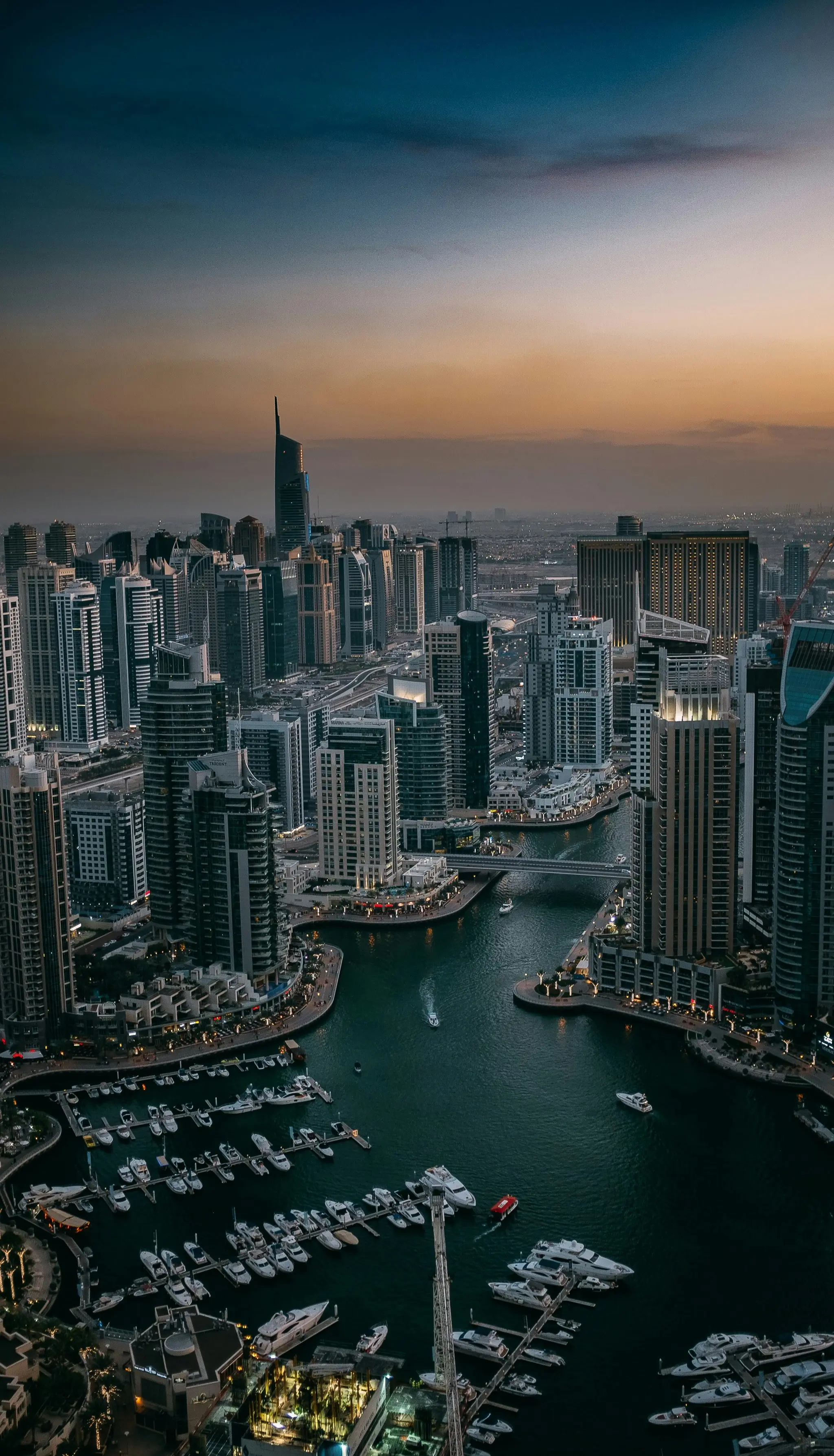 Aerial view of Dubai Marina and its yachts at dusk